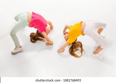 The Kids Dance School, Ballet, Hiphop, Street, Funky And Modern Dancers On White Studio Background. Girl Is Showing Aerobic And Dance Element. Teen In Hip Hop Style