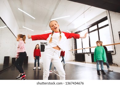 The Kids At Dance School. Ballet, Hiphop, Street, Funky And Modern Dancers Over Studio Background. Children Showing Aerobic Element. Teens In Hip Hop Style. Sport, Fitness And Lifestyle Concept.