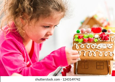 Kids Decorating Small Gingerbread Houses At The Christmas Craft Party.