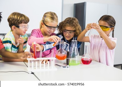 Kids doing a chemical experiment in laboratory at school