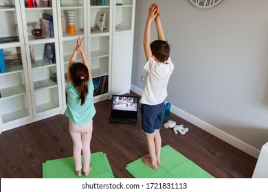 Kids Doing Yoga At Home Online Laptop Workout In Flat. Baby Yoga,fitness Training. Quarantine, Coronavirus, Covid-19. No Equipment.