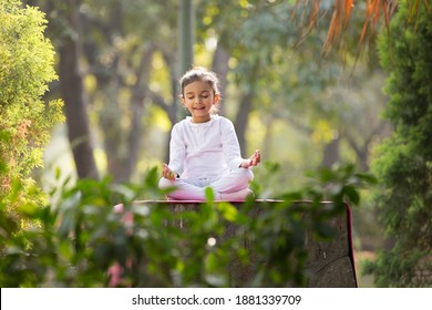 Kids Doing Yoga Pose In The Park Outdoor