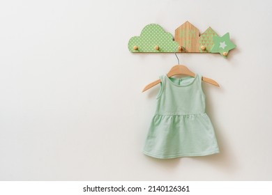 Kids Dress Made From Organic Cotton On The Decorative Rack On White Background With Blank Space For Text.