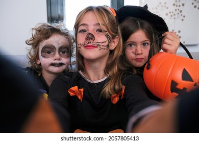 Kids Dressed Up For Halloween Taking A Selfie. Family Halloween Party