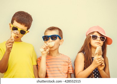 Kids Eating Gelato And Soft Serve Ice Cream. Boys And Little Girl In Sunglasses Enjoying Summer Holidays Vacation. Instagram Filter.