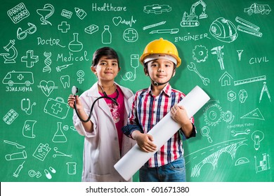 Kids and education concept - Small indian boy and girl posing in front of Green chalk board in engineers fancy dress with yellow helmet and doctor costume with stethoscope, wanna be engineer or doctor - Powered by Shutterstock