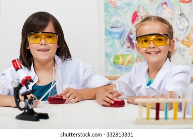 Kids In Elementary Science Class Doing Chemical Experiments-focus On Boy Face