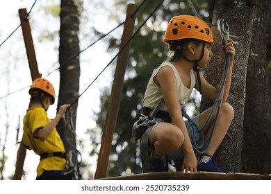 Kids Enjoying Outdoor Adventure with Climbing Gear and Helmets in Tree-Top Obstacle Course - Powered by Shutterstock