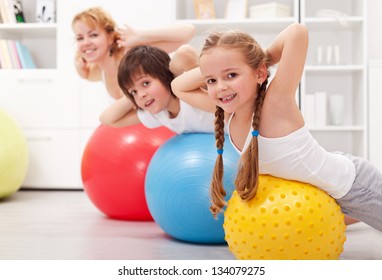 Kids Exercising With Their Mother At Home