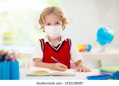 Kids in face mask in school class. Child back to school after coronavirus lockdown. Primary child in covid-19 pandemic. Safety and virus spread prevention. Student in surgical mask. Social distancing.
