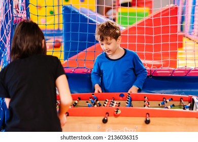 Kids Family Playing Table Football Together At Children's Play Center.