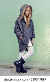 Kids Fashion. Beautiful Young Little Girl In Winter Coat And Boots Outdoor. Children's Clothing.