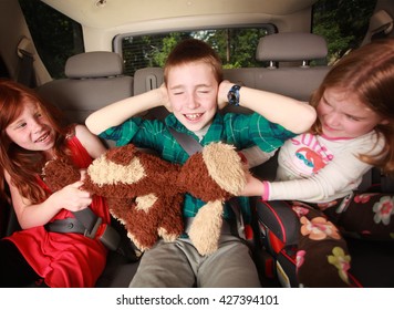 Kids fighting in the backseat of a car