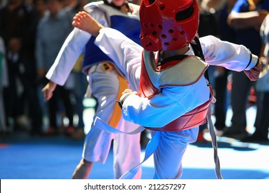 Kids Fighting On Stage During Taekwondo Tournament