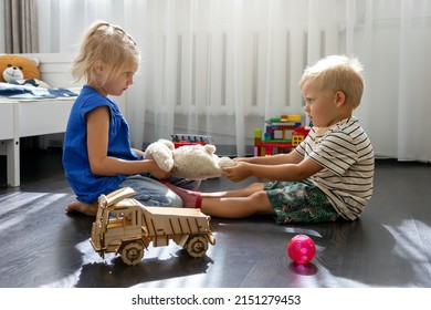 kids are fighting over a toy. conflict between sister and brother. sibling relationships - Shutterstock ID 2151279453