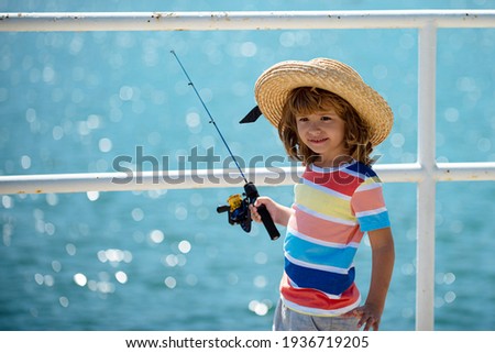 Kids fishing. Child fishing on the lake. Young fisher. Boy with spinner at river.Boy fishing at jetty with rod