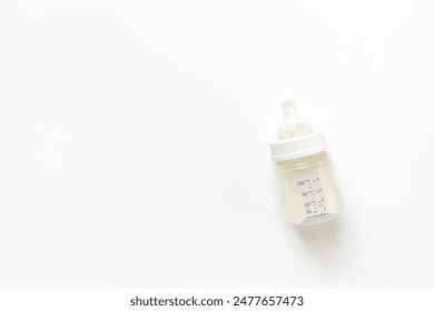 Kids flat lay with milk for baby feeding in bottle, top view.