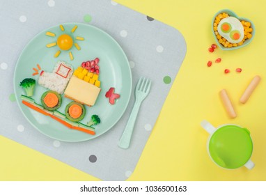 Kids Food Art Concept: Car From Rice, Sandwich And Fresh Fruits And Vegetables On The Yellow Background; Top View, Flat Lay