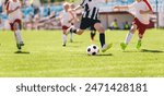 Kids as Football Soccer Players Running with Ball. Footballers Kicking Play League Match During Sunny Day. Two Teams in Sport Competition. Teenage Soccer Players Running in a Duel and Kicking Ball