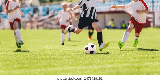 Kids as Football Soccer Players Running with Ball. Footballers Kicking Play League Match During Sunny Day. Two Teams in Sport Competition. Teenage Soccer Players Running in a Duel and Kicking Ball - Powered by Shutterstock