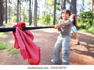 Kids, game and tug of war in forest at summer camp and holiday with travel and energy outdoor. Children with rope, adventure and team building with fun contest, playful and young friends in a park - Powered by Shutterstock