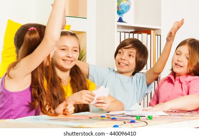 Kids Giving Hive Five Sitting At The Gaming Table