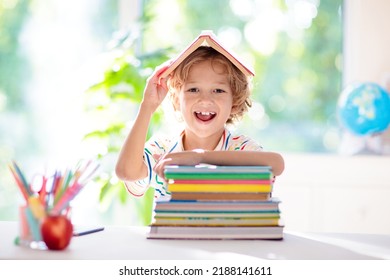 Kids go back to school. Children study and learn for preschool. Little boy of elementary class doing homework. Bedroom with desk, books and globe for young child. Kid learning to read and write.