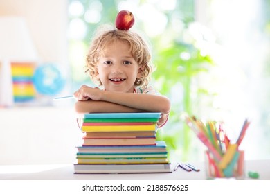 Kids go back to school. Children study and learn for preschool. Little boy of elementary class doing homework. Bedroom with desk, books and globe for young child. Kid learning to read and write. - Shutterstock ID 2188576625
