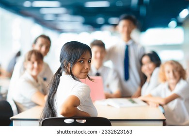 Kids go back to school. Interracial group of children of mixed age on the first day of new academic year. Teenager in classroom. High and middle school students walk to lesson. Secondary student class