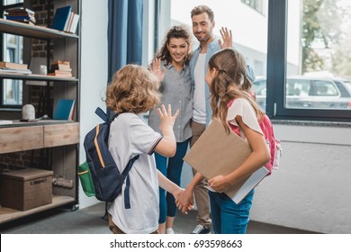 Kids Going To School And Waving To Parents