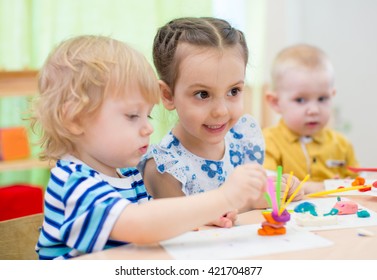 Kids Group Doing Arts And Crafts In Kindergarten