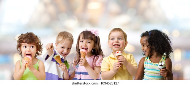 Kids Group Eating Ice Cream At A Party In Cafe