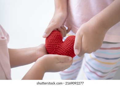 Kids Hand Giving And Receiving Heart Health Care Concept. Two Kids Sharing Love Childhood.