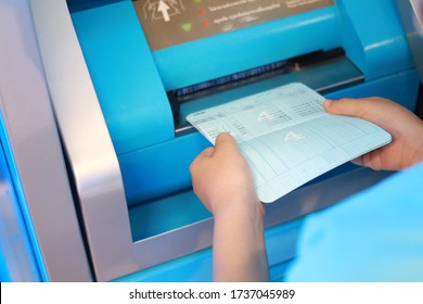 Kids Hand Hold Bank Account Passbook Insert Into Bank Machine For Update An Account Book 