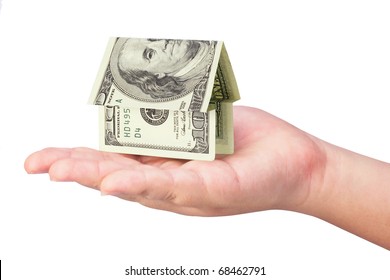 Kid's hand holding money house on white background - Powered by Shutterstock