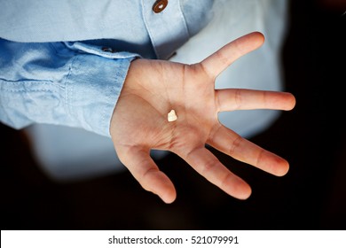 Kids Hand With One Milk Tooth. First Tooth Lost.