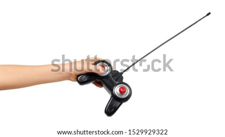 Kids hand with plastic RC transmitter. Remote control receiver for toys. Isolated on white background.