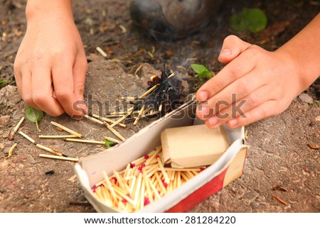 kids hand play with box of matches