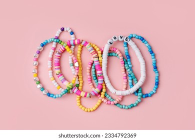 Kids handmade beaded jewelry. Necklaces and bracelets made from multicolored beads and pearls. DIY bracelet beads. Children's needlework. Creativity and hobby. Art activity for kids