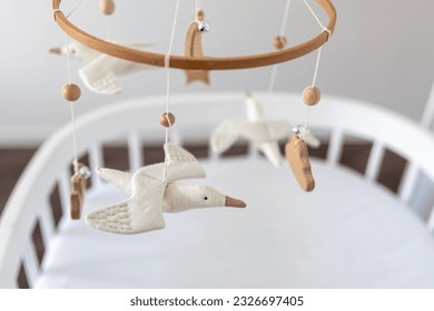 Kids handmade toys above the newborn crib. - Powered by Shutterstock