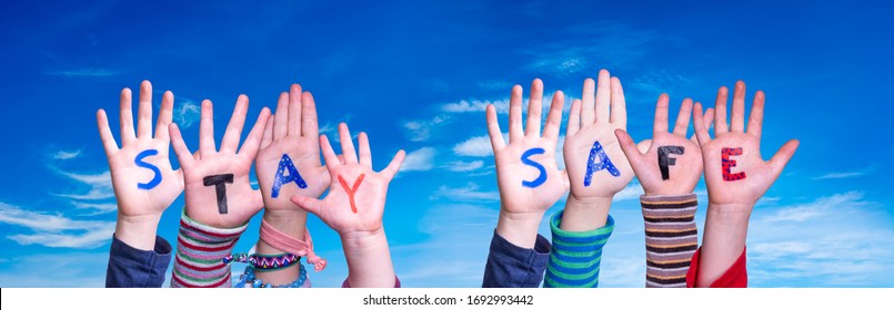 Kids Hands Holding Word Stay Safe, Blue Sky