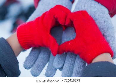 Kids Hands In Winter Red Gloves Heart Symbol Shaped Lifestyle And Feelings Concept,  Making Heart Symbol In Winter, Mom And Son Or Mom And Daughter, Family And Love