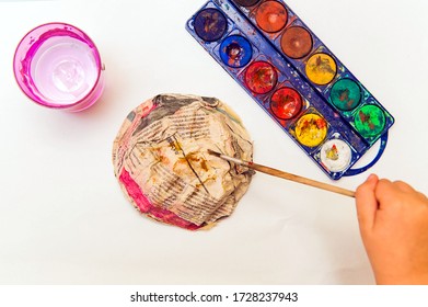 Kids Hanm Painting Paper Mache Molds Using Brush And Paints