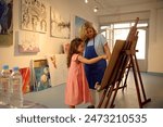 Kids have art class, drawing, painting with teacher in workshop