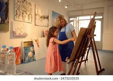 Kids have art class, drawing, painting with teacher in workshop - Powered by Shutterstock