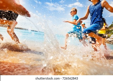 Kids Having Fun Run Make Splashes In Shallow Water