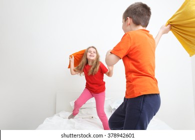 Kids Having A Pillow Fight In Bed