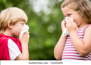 Kids With Hay Fever Or The Flue Sneezing And Cleaning Nose With Tissue