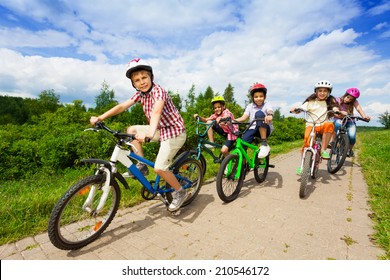 Kids In Helmets Riding Bikes Together