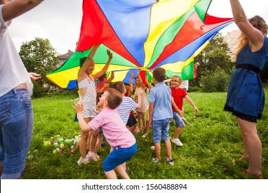 Kids Hide Under Rainbow Parachute Outdoors Game